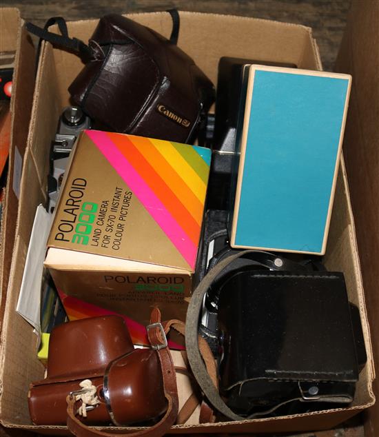 A collection of cameras including a Canon slr